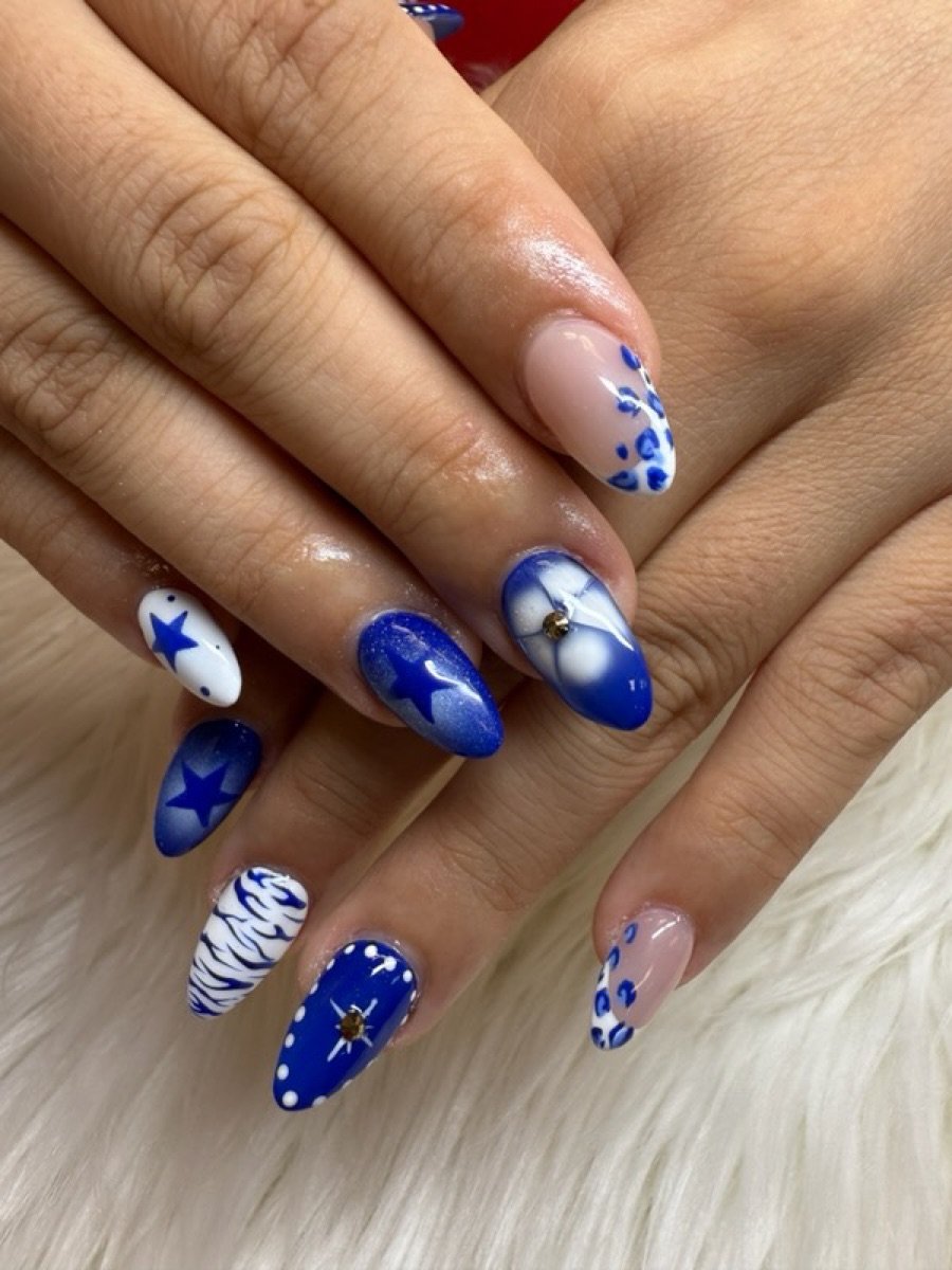 Blue and white star nail art set done at Color Nails Club